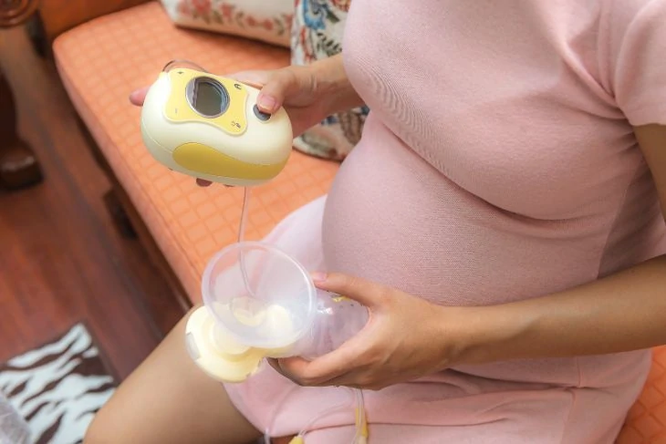 Woman holding the Medela Freestyle Electric Breast Pump