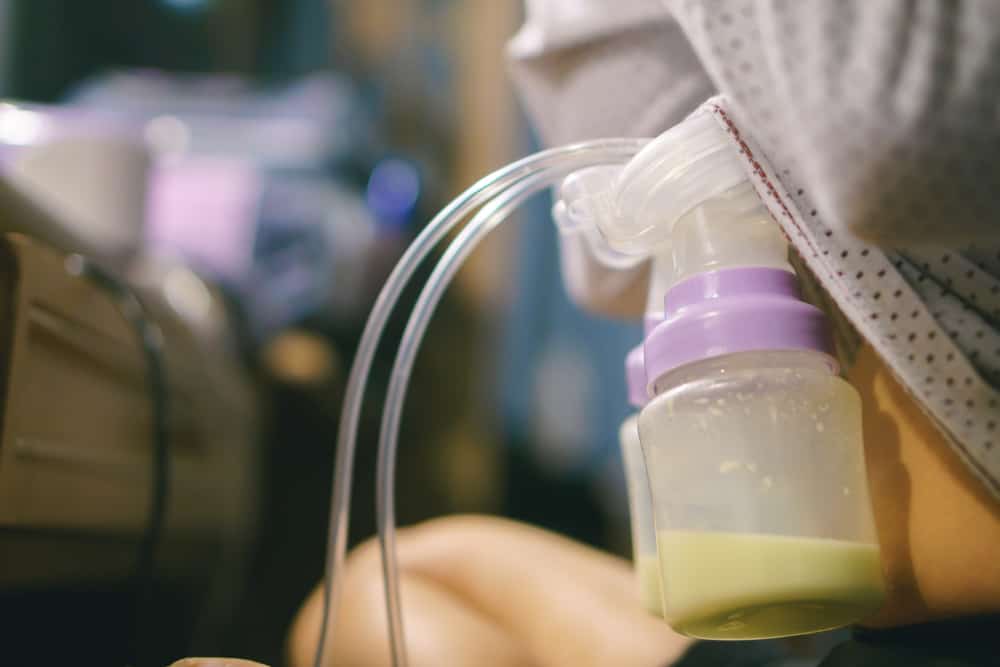 Woman pumping her breasts with breast pump in public