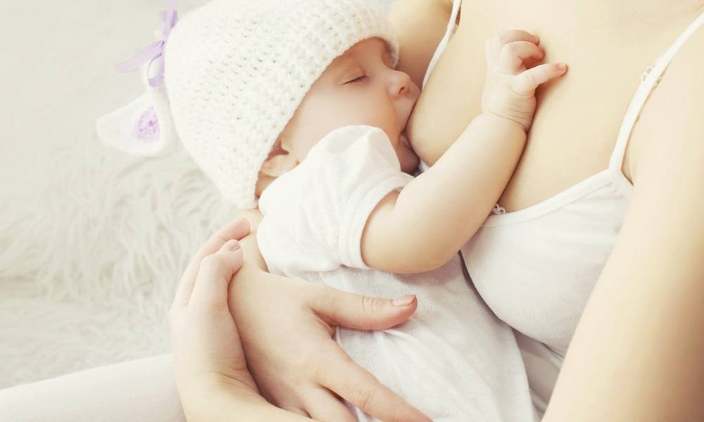 Mom breastfeeding baby girl