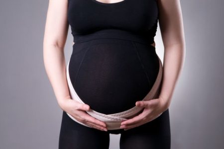 Pregnant woman wearing a maternity belt