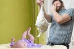 Father changing dirty stinky diaper