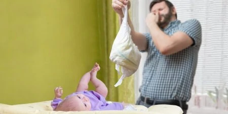 Father changing dirty stinky diaper