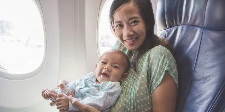 Breast Pumping Mother and baby in airplane
