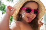 Baby girl wearing sunglasses on the beach