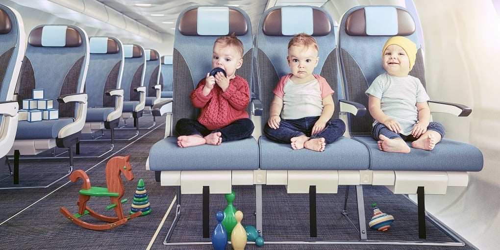 Surviving Baby’s First Flight: 6 Things You Should Never Fly Without 3 Baby sitting on the airplane waiting to travel