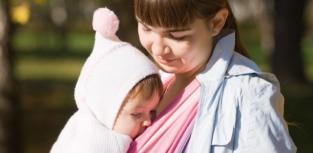 Baby breastfeeding in sling