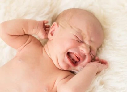 Constipated newborn baby crying