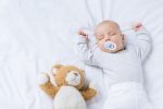 Baby sleeping while using pacifier