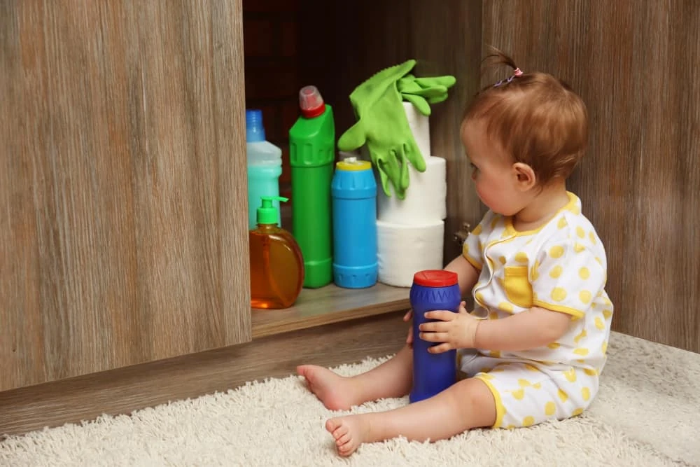 Baby looking through sink cabinets