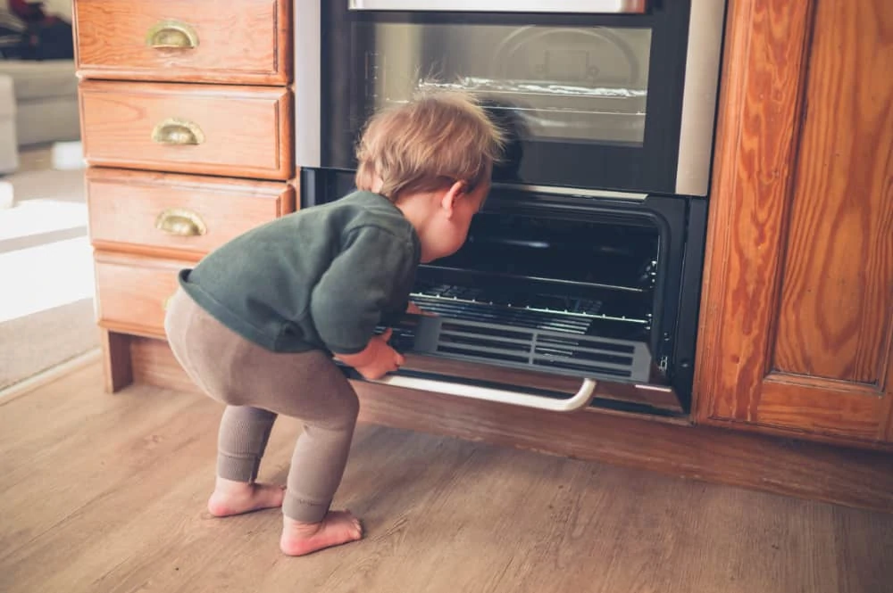 Baby looking inside the oven