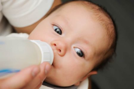 Baby drinking from bottle nipple