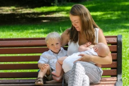 Mother breastfeeding in public at the park