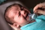 Crying baby using pacifier