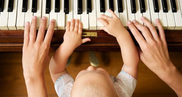 Baby Playing Piano With Mother