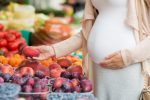 Pregnant woman picking fruits