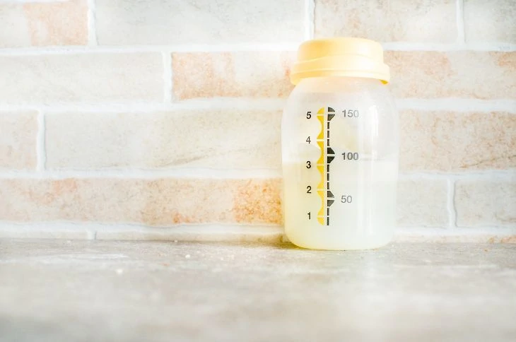 Bottle of pumped breastmilk with a light white color