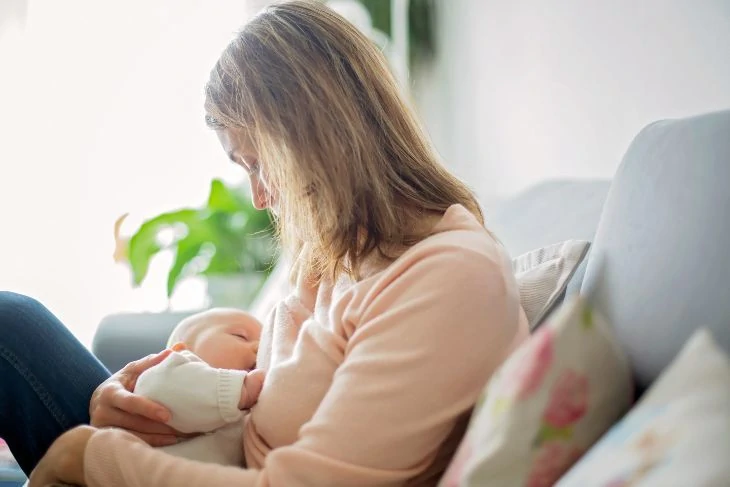 Mom breastfeeding on the sofa