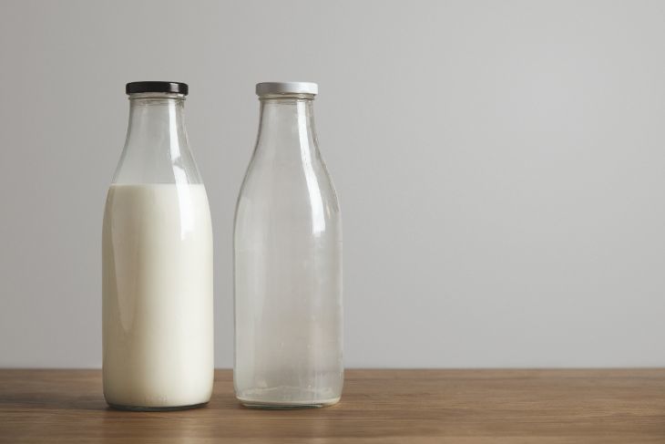 Bottles of milk, one full, the other empty