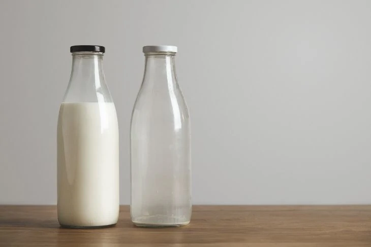 Bottles of milk, one full, the other empty