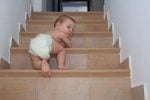 Toddler climbing up the stairs unsupervised