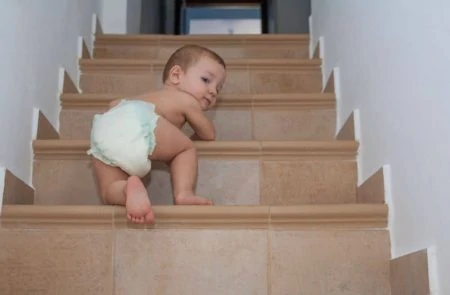 Toddler climbing up the stairs unsupervised
