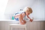 Toddler climbing into the bathtub unsupervised