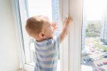 Toddler playing by the window unsupervised