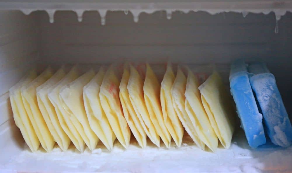 Packs of frozen breast milk in the freezer