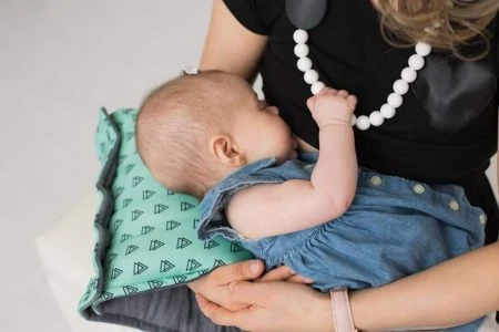 Mother breastfeeding her baby wearing a nursing dress