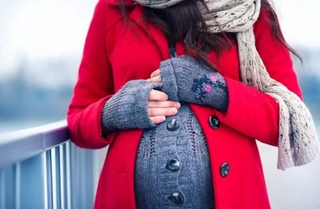 Pregnant woman wearing a coat