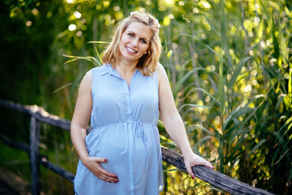 Smiling pregnant woman wearing a dress