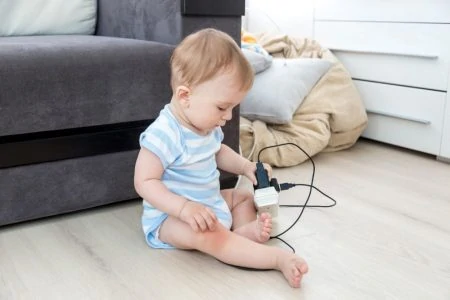 Toddler playing with electrical chord
