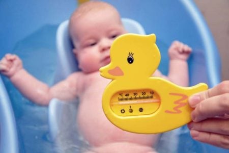 Mom holding a bath thermometer