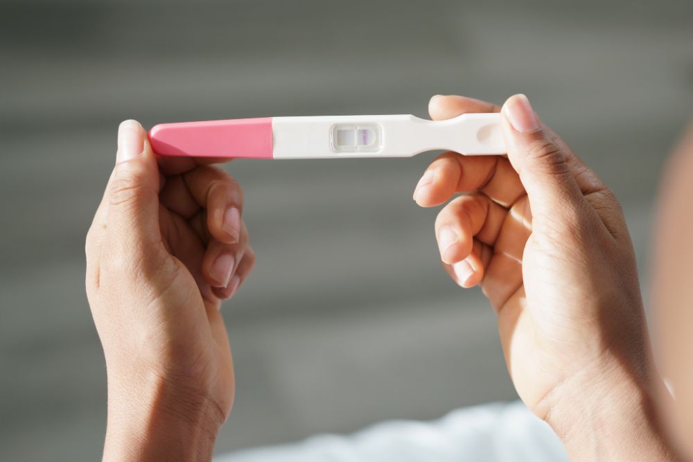 Woman holding a negative pregnancy test