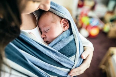 Mother holding her baby in a wrap