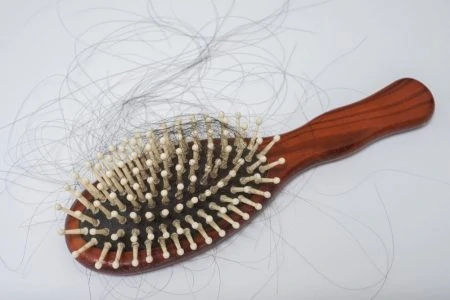 Hair brush with postpartum woman's hair