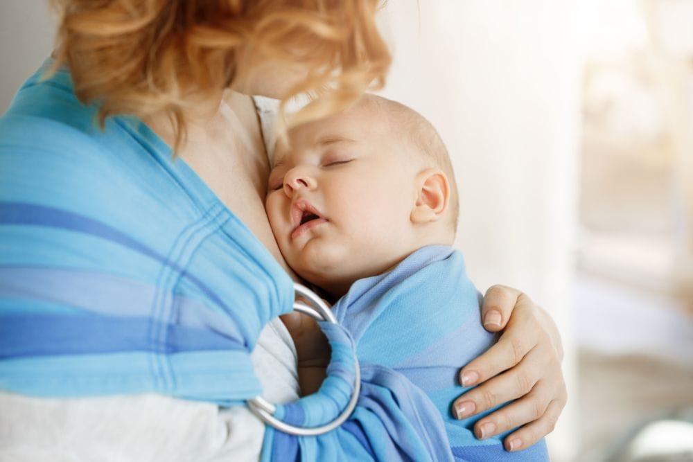 Mom carrying baby in a ring sling