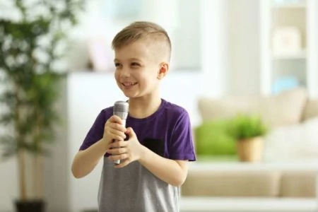Little boy holding a karaoke mic