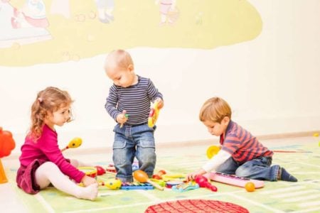Toddlers playing with musical toys