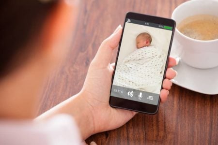 Mother using a baby monitor app on her phone