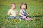 Smiling children sitting on the grass