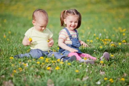 Smiling children sitting on the grass