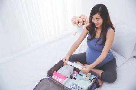 Pregnant woman organizing clothes
