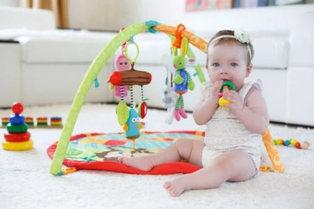 Baby girl playing with activity center