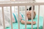 Baby boy sleeping in a crib