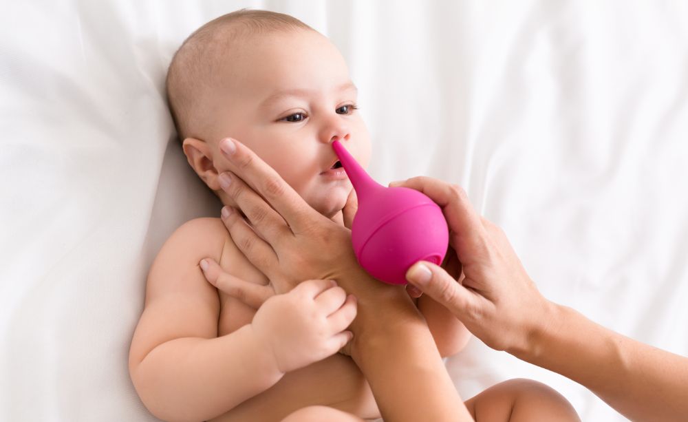 Cleaning baby's nose with a bulb syringe