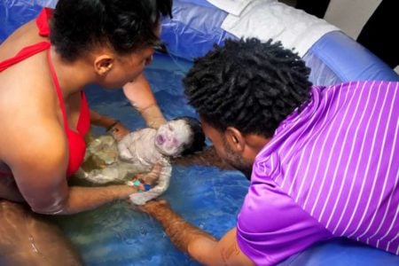 Woman delivering water birth