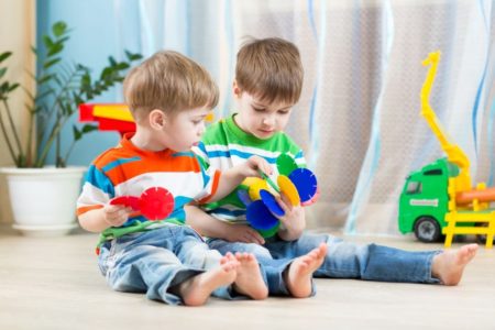 Two small boys playing with educational toy