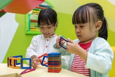 Asian children playing with magnetic toys