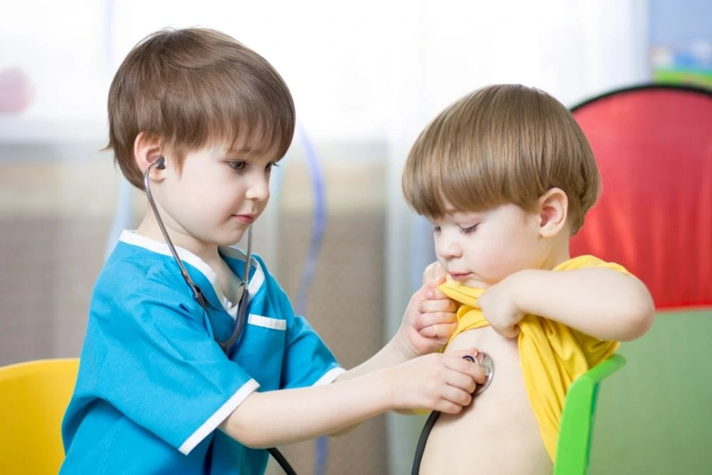 Two little boys playing with stethoscope